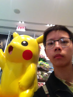A picture of me with a Pikachu statue.
